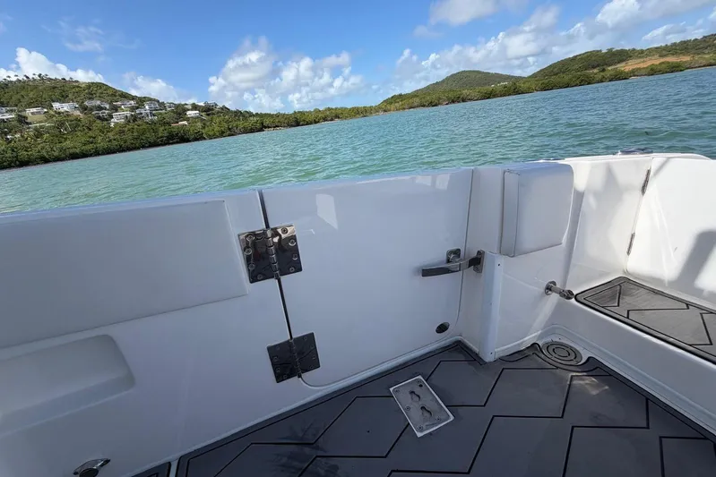  Yacht Photos Pics 2023 Fountain 34 Center Console boat on scenic water with lush green hills.