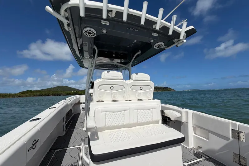  Yacht Photos Pics 2023 Fountain 34 Center Console boat on water, featuring sleek seating and canopy.
