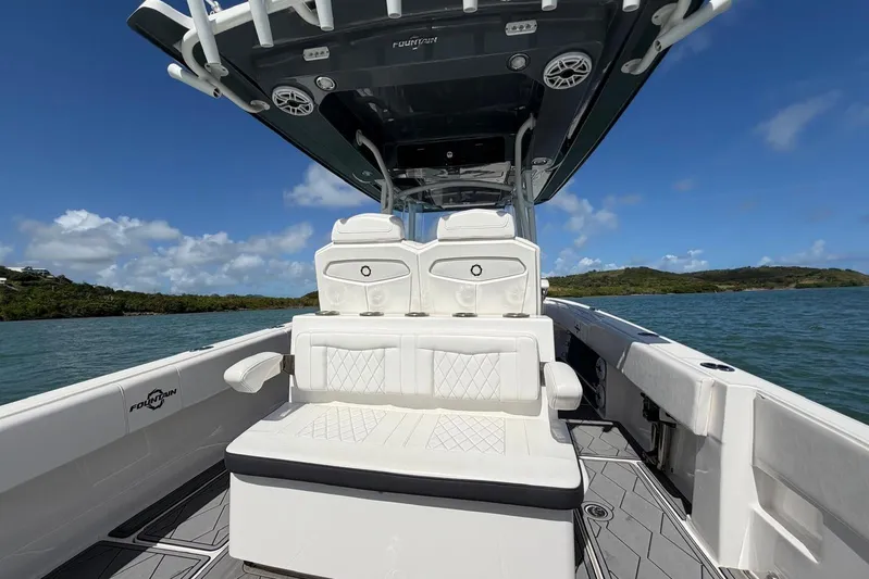  Yacht Photos Pics 2023 Fountain 34 Center Console boat interior with white seating, on a sunny day.