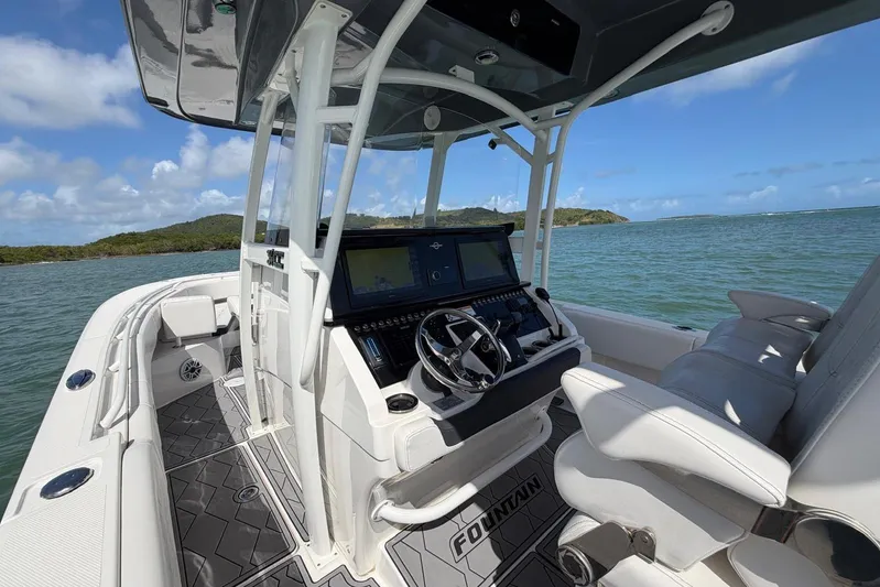  Yacht Photos Pics 2023 Fountain 34 Center Console boat interior with steering wheel and navigation screens.