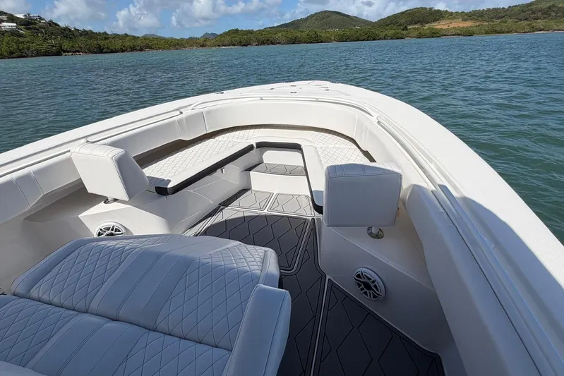  Yacht Photos Pics 2023 Fountain 34 Center Console boat interior with luxurious seating on calm water.