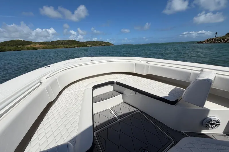  Yacht Photos Pics 2023 Fountain 34 Center Console boat interior with luxurious seating, on a scenic waterway.