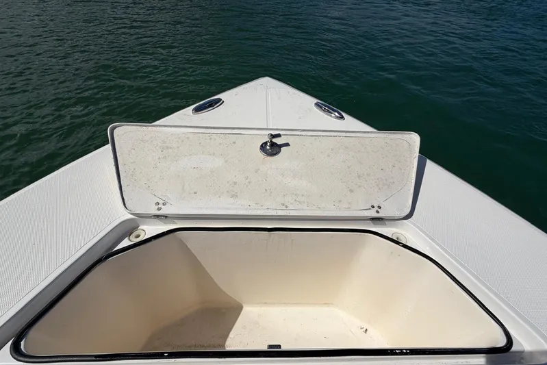  Yacht Photos Pics Open storage compartment on 2023 Fountain 34 Center Console boat, near water.