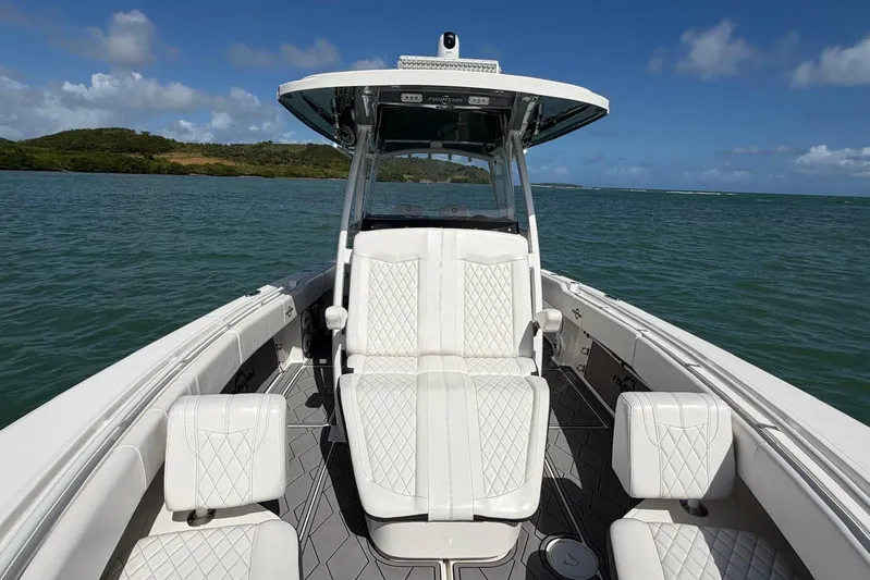  Yacht Photos Pics 2023 Fountain 34 Center Console boat on water, featuring luxurious seating and sleek design.