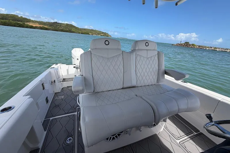  Yacht Photos Pics 2023 Fountain 34 Center Console boat with luxurious seating on calm waters.
