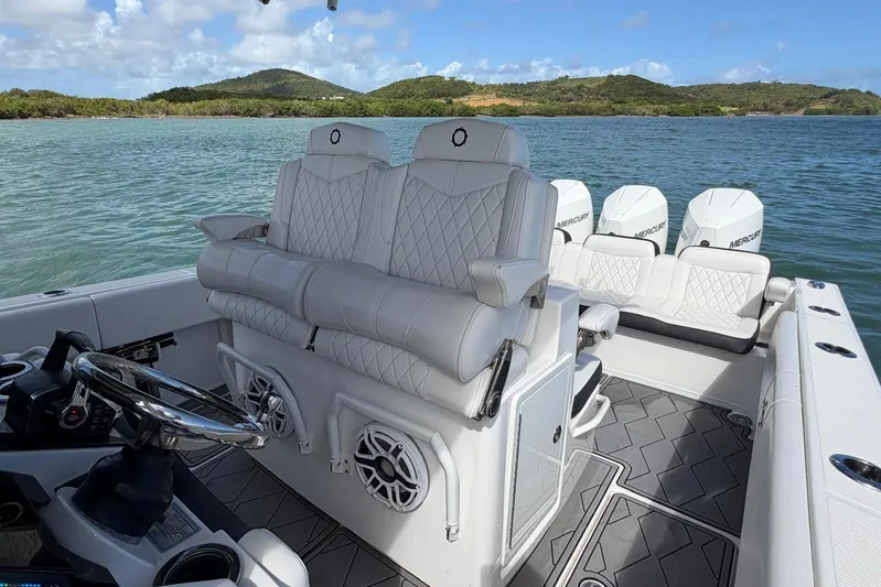  Yacht Photos Pics 2023 Fountain 34 Center Console boat interior with luxurious seating and scenic water view.