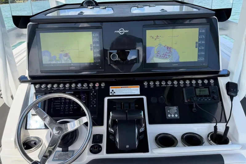  Yacht Photos Pics 2023 Fountain 34 Center Console dashboard with dual Garmin displays and steering wheel.