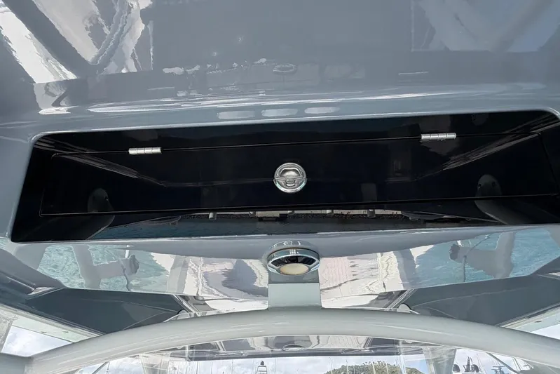  Yacht Photos Pics 2023 Fountain 34 Center Console boat storage compartment with sleek design and secure latch.