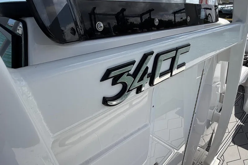  Yacht Photos Pics 2023 Fountain 34 Center Console boat, close-up of "34CC" emblem on white exterior.