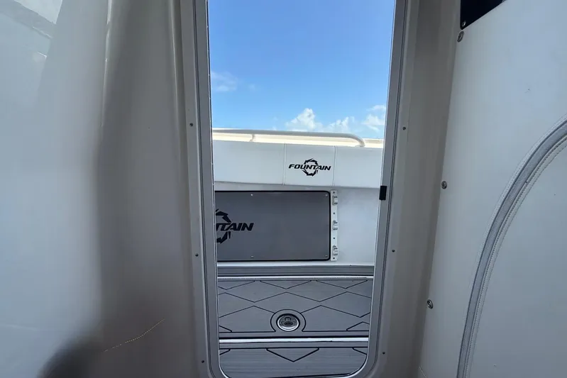  Yacht Photos Pics 2023 Fountain 34 Center Console boat interior with open door and logo view.