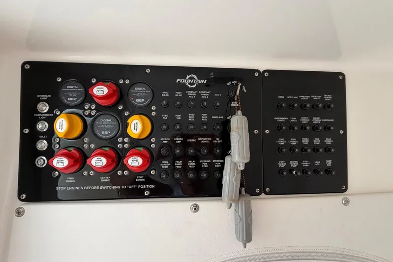  Yacht Photos Pics Control panel of 2023 Fountain 34 Center Console boat with switches and indicators.