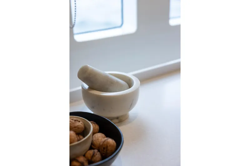 Spice Of Life II Yacht Photos Pics Marble mortar and pestle on Sunreef 60 yacht, 2025 model, with walnuts nearby.