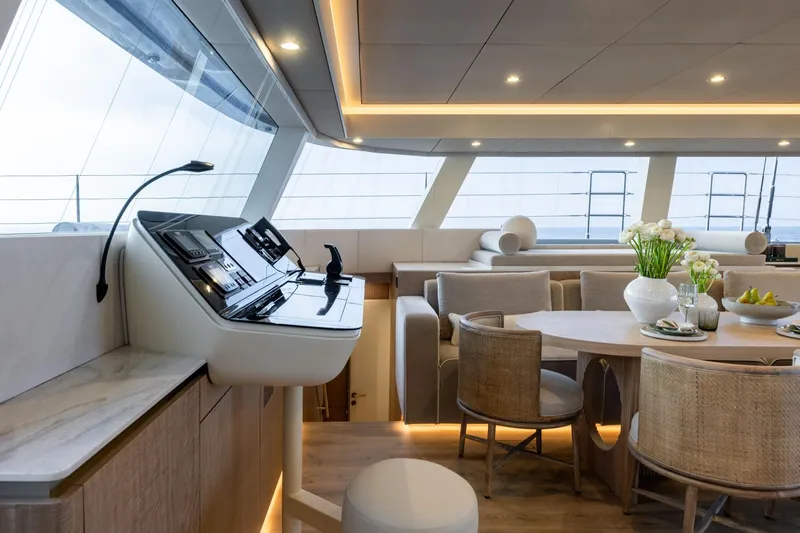 Spice Of Life II Yacht Photos Pics Luxurious interior of 2025 Sunreef 60 yacht with modern helm and elegant dining area.