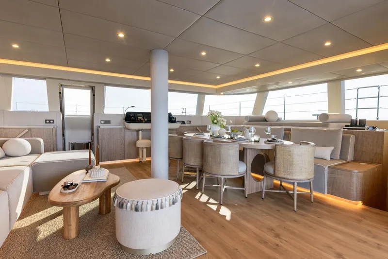 Spice Of Life II Yacht Photos Pics Luxurious interior of 2025 Sunreef 60 yacht with elegant dining and seating area.