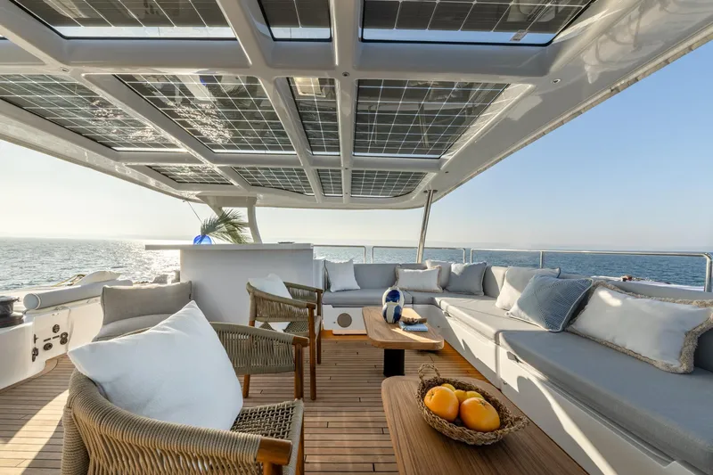 Spice Of Life II Yacht Photos Pics Luxurious Sunreef 60 yacht deck with solar panels, elegant seating, and ocean view, 2025 model.