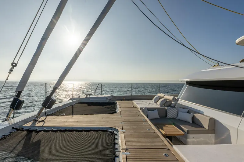 Spice Of Life II Yacht Photos Pics Luxurious Sunreef 60 yacht deck with seating, ocean view, and sunset, 2025 model.