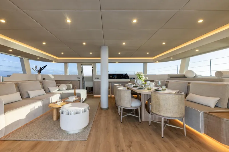 Spice Of Life II Yacht Photos Pics Luxurious interior of 2025 Sunreef 60 yacht with elegant seating and dining area.