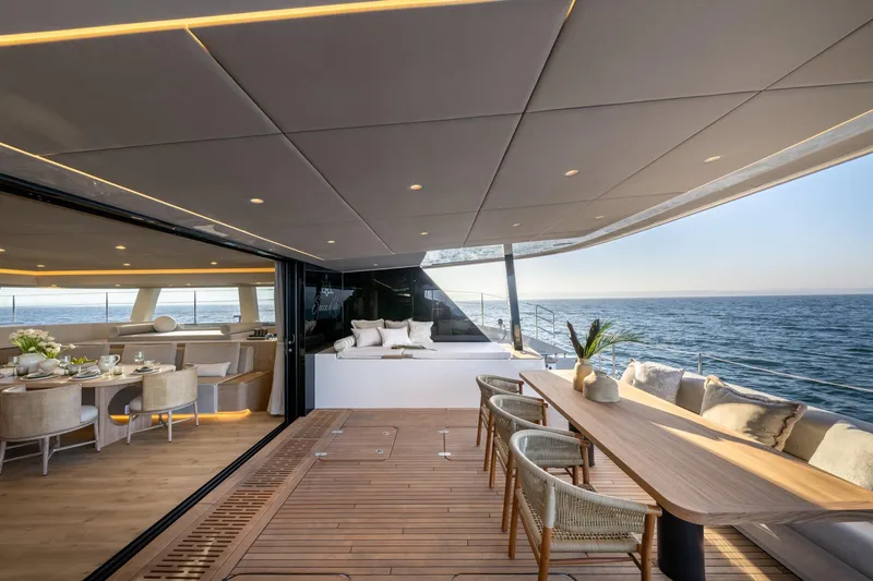 Spice Of Life II Yacht Photos Pics Luxurious Sunreef 60 yacht interior, featuring elegant dining and seating areas with ocean views, 2025 model.