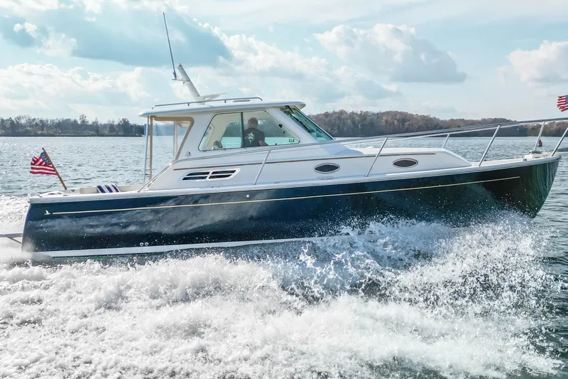 Yacht Photos Pics 2008 Back Cove 29 boat cruising on a sunny day with American flags.