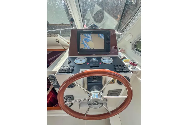  Yacht Photos Pics 2008 Back Cove 29 helm with GPS navigation, wooden steering wheel, and control panel.
