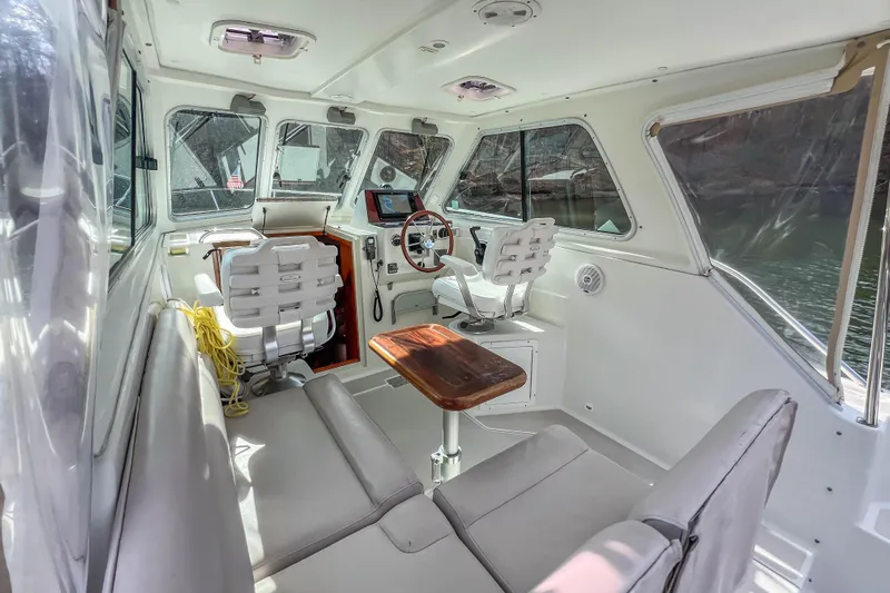  Yacht Photos Pics 2008 Back Cove 29 boat interior with seating, steering wheel, and navigation equipment.