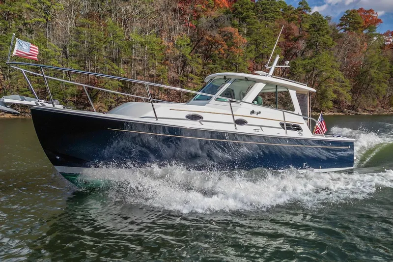  Yacht Photos Pics 2008 Back Cove 29 cruising on a scenic lake with American flags.