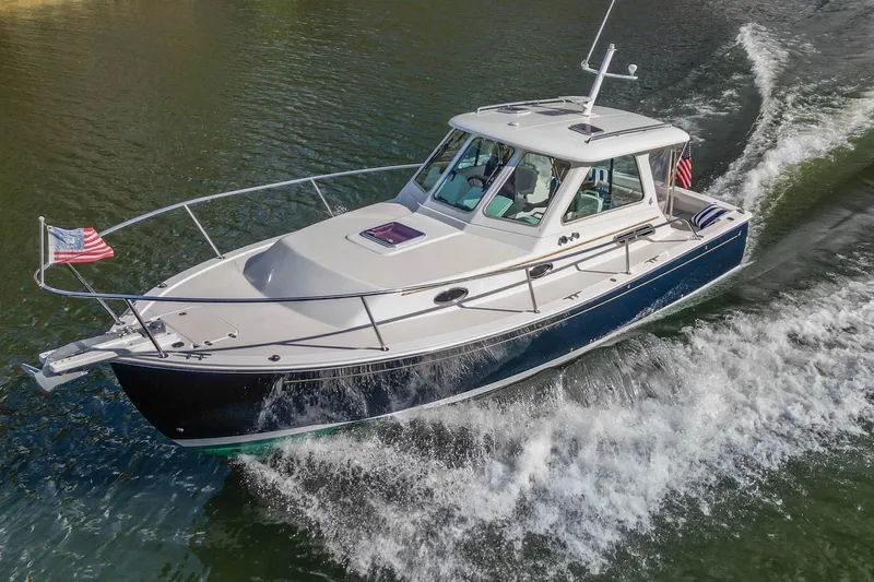  Yacht Photos Pics 2008 Back Cove 29 boat cruising on water with American flag.