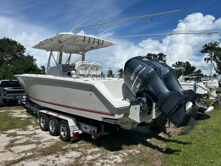  Yacht Photos Pics 2013 Jupiter 34 boat with dual Yamaha engines on a trailer, under a clear blue sky.