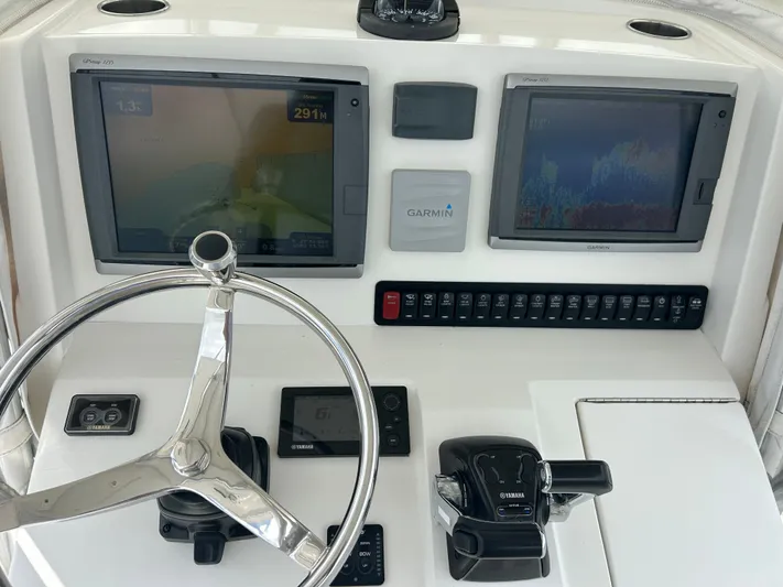  Yacht Photos Pics Control panel of a 2013 Jupiter 34 boat with Garmin navigation displays.