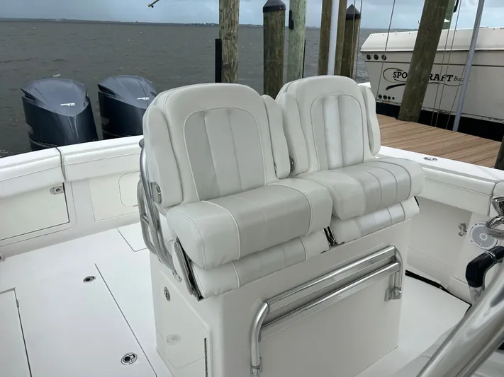  Yacht Photos Pics White leather seats on a 2013 Jupiter 34 boat, docked with twin outboard motors.