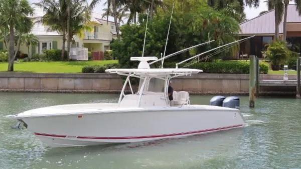  Yacht Photos Pics 2013 Jupiter 34 boat docked near waterfront homes with palm trees.