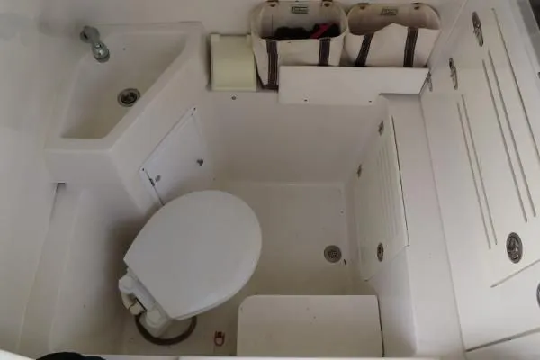  Yacht Photos Pics Compact bathroom in a 2013 Jupiter 34 boat with toilet and sink.