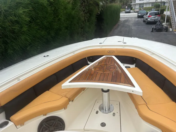  Yacht Photos Pics 2014 Scout 350 LXF boat with tan seating and wooden table on deck.
