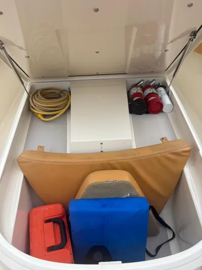  Yacht Photos Pics Storage compartment of 2014 Scout 350 LXF boat with safety equipment and supplies.