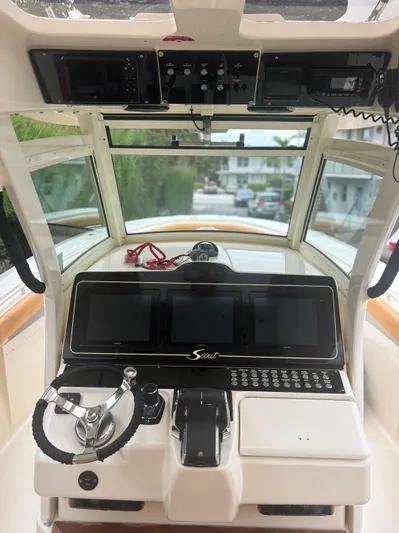  Yacht Photos Pics 2014 Scout 350 LXF boat cockpit with advanced navigation system and steering wheel.