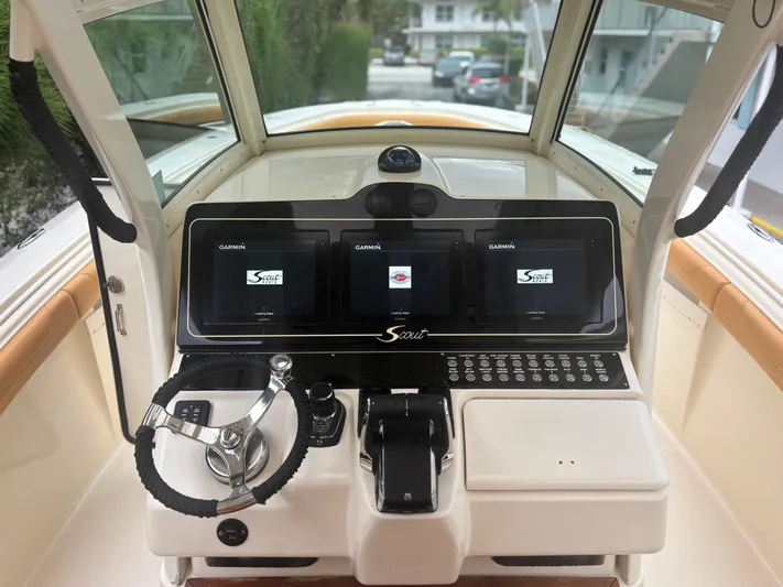  Yacht Photos Pics 2014 Scout 350 LXF boat dashboard with steering wheel and digital displays.
