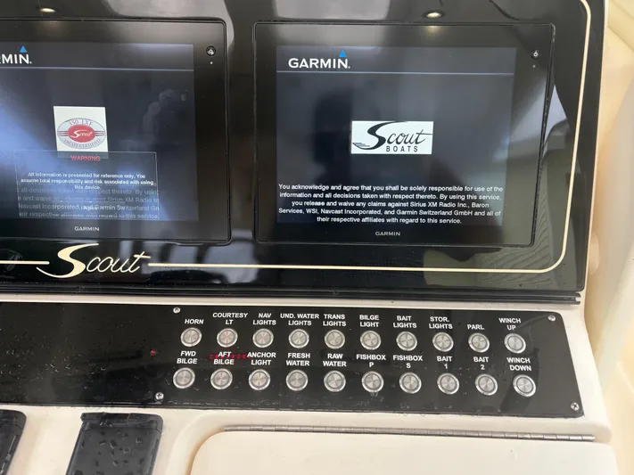  Yacht Photos Pics Control panel of a 2014 Scout 350 LXF boat with Garmin displays and various switches.