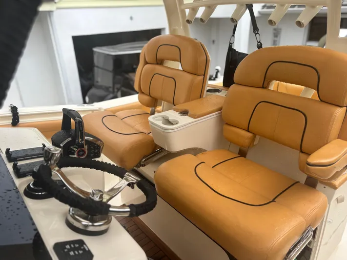  Yacht Photos Pics 2014 Scout 350 LXF boat interior with tan leather seats and steering wheel.