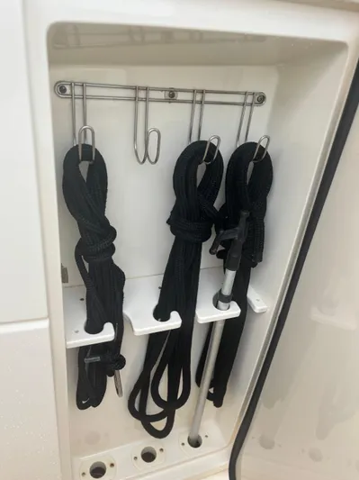  Yacht Photos Pics Boat storage compartment with neatly organized black ropes and hooks on a 2014 Scout 350 LXF.