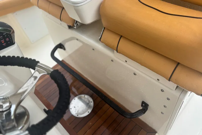  Yacht Photos Pics Interior view of 2014 Scout 350 LXF boat with tan seating and steering wheel.