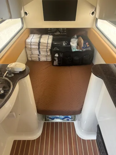  Yacht Photos Pics 2014 Scout 350 LXF cabin interior with bed, sink, and storage.