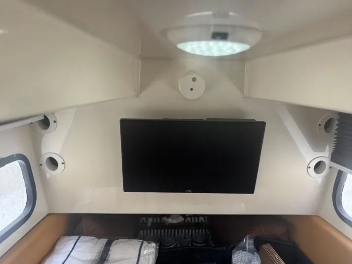  Yacht Photos Pics Interior cabin of 2014 Scout 350 LXF boat with TV and windows.