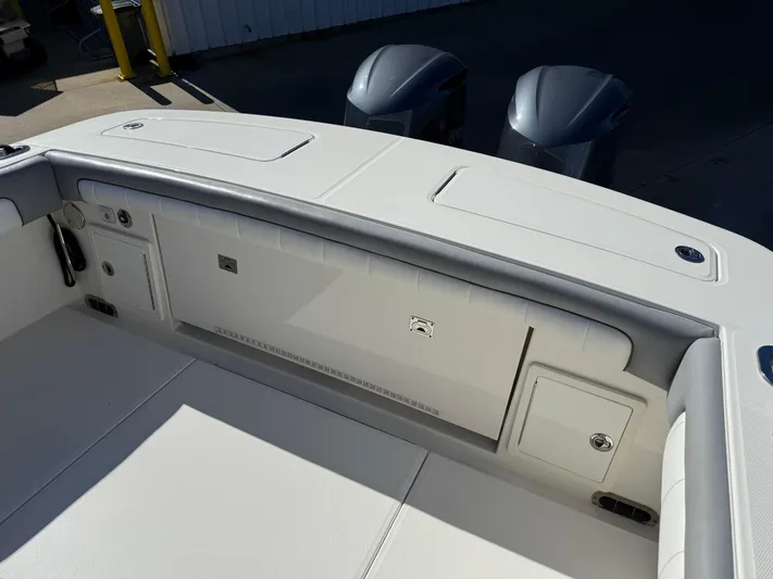 Deadicated Yacht Photos Pics 2019 Regulator 31 boat interior with storage compartments and twin outboard engines.