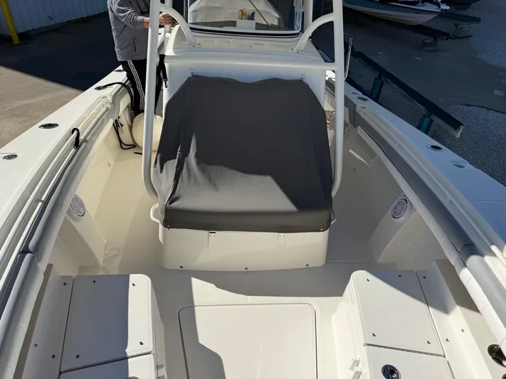Deadicated Yacht Photos Pics 2019 Regulator 31 boat interior with seating and console, showcasing spacious design.