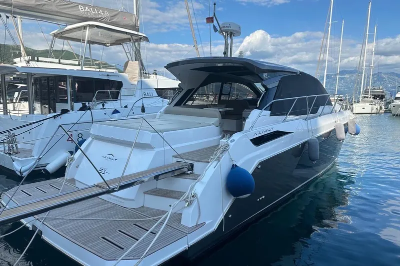  Yacht Photos Pics 2024 Azimut Atlantis 51 yacht docked in marina, featuring sleek design and luxurious amenities.