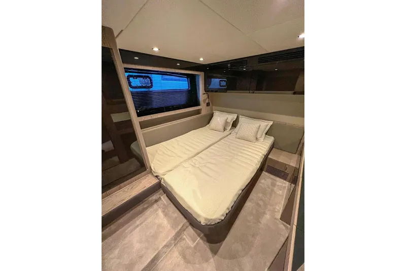  Yacht Photos Pics Luxurious interior cabin of 2024 Azimut Atlantis 51 yacht with cozy bedding.