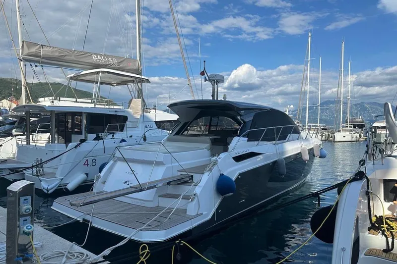  Yacht Photos Pics 2024 Azimut Atlantis 51 yacht docked in a marina, surrounded by other boats.