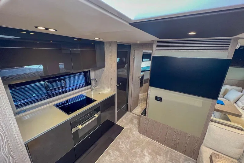  Yacht Photos Pics Modern kitchen interior of 2024 Azimut Atlantis 51 yacht, featuring sleek design and appliances.