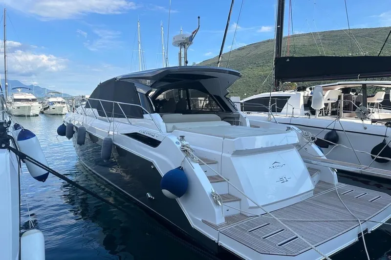  Yacht Photos Pics 2024 Azimut Atlantis 51 yacht docked in a marina, surrounded by other boats.