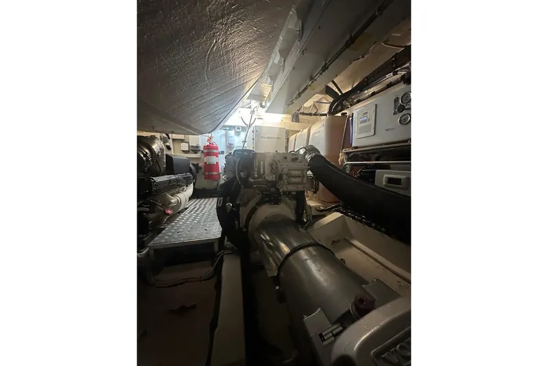  Yacht Photos Pics Engine room of 2024 Azimut Atlantis 51 yacht, showcasing mechanical components and fire extinguisher.